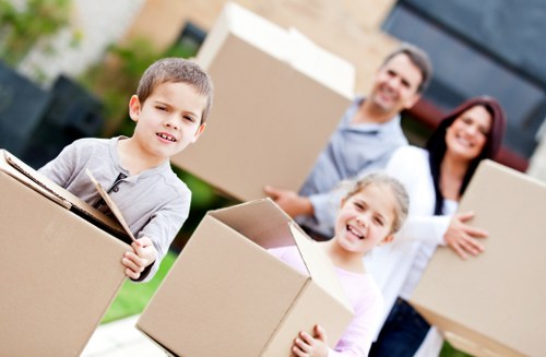 Two movers handling household items with care during a removals job