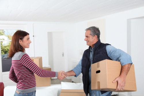 Trained removals staff handling boxes and furniture carefully