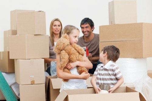 Local movers navigating a Colindale apartment building with furniture